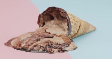 Time lapse, Melting chocolate ice cream on  waffle cone. flow of chocolate. On the two tone background. video