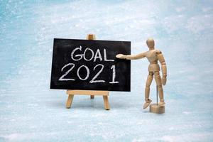 The message GOAL 2021 is written in white chalk on a black chalk board. photo