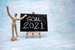 The message GOAL 2021 is written in white chalk on a black chalk board. photo