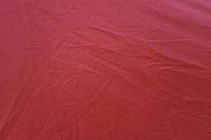Wrinkled red canvas. Red textured background. Red canvas abstract background photo