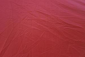 Wrinkled red canvas. Red textured background. Red canvas abstract background photo