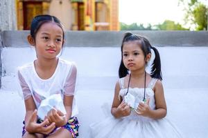 Two Asian girls in a Buddhist temple during the day photo