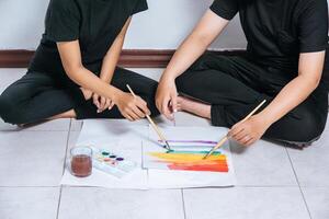 Female couples draw and paint on paper. photo