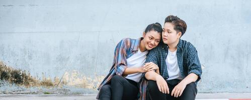 A woman sitting on each other's shoulders by the road. photo