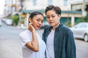 A couple of women standing and looking forward. photo