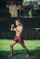 A boxer tied a rope in his hand and performed a fight, The martial arts of Muay Thai. photo