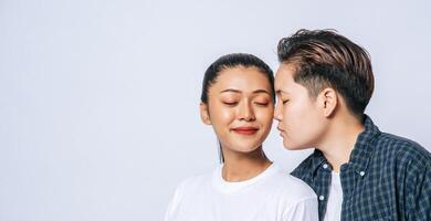 Women couples stand and fragrant cheek. photo