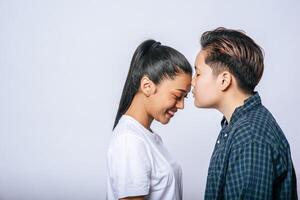 Women couples stand and fragrant cheek. photo