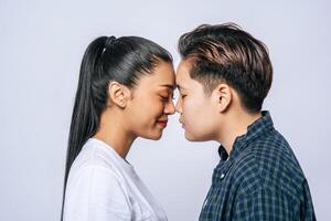 Women couples stand and fragrant cheek. photo