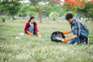 Men and women help each other to collect garbage. photo