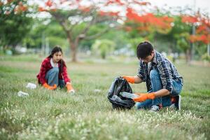 Men and women help each other to collect garbage. photo