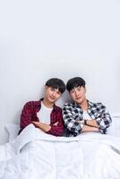 Two beloved young men slept in bed together. photo