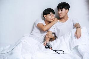 Two beloved young men slept in bed together. photo