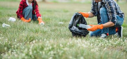 Men and women help each other to collect garbage. photo