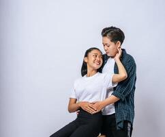 Two female lovers standing and hugging from behind. photo