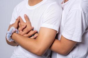 Two men who love each other hug from behind another. photo