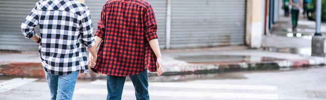 Two men who love each other hold hands and walk together. photo