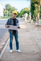 Architects hold the building plan and check the work. photo