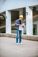 Architects hold the building plan and check the work. photo