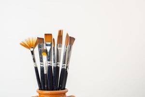 brushes with oil paint on a white background photo