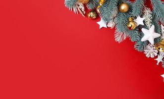 Flat lay christmas decorations on red background with copy space photo