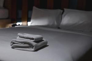 The towels are folded and placed on the bed for the hotel guests. photo