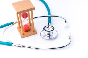 stethoscope and hourglass for doctor and medical nursing people check up healing of patients photo