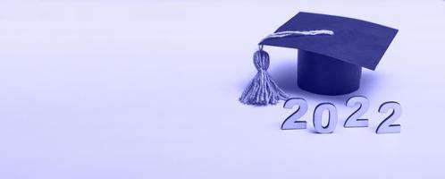Gift box in the form of a graduation cap. 2022 release concept on very peri background copy space. Banner photo