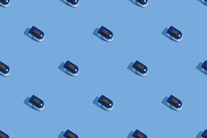 Portable pulse oximeter on a blue background with a hard shadow. Control of oxygen in the lungs. view from above.Pattern photo