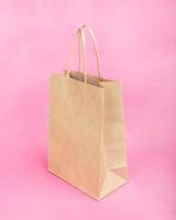 paper shopping bag on beauty pink background photo