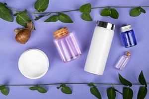 jars with body care cosmetics on purple background beauty