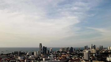Top view, In a sunny day the sky is bright.  Above the tall buildings and the sea.