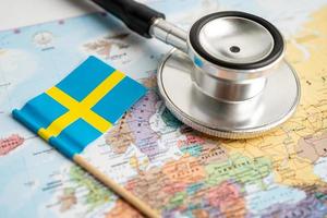 Bangkok, Thailand - June 1, 2021, Stethoscope on Sweden world globe map background. photo