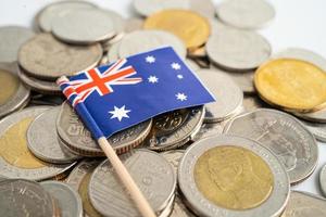 Australia flag on coins background, finance and accounting, banking concept.