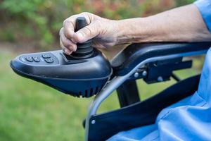 Asian senior or elderly old lady woman patient on electric wheelchair with remote control at nursing hospital ward, healthy strong medical concept photo