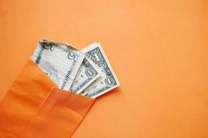 us dollar in a orange color envelope photo