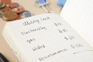 list of utility bills on a paper on table photo