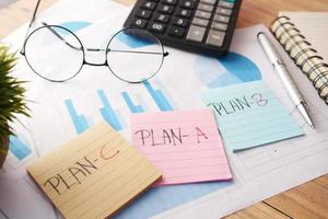 financial graph, calculator and notepad on table photo