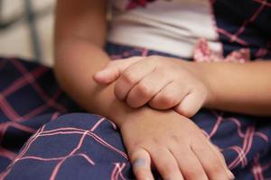 child girl suffering from itching skin on hand photo