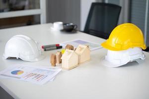 Hard hat helmet on desk engineer home construction project photo