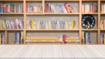 Wooden table in the library with a blurred bookshelf with many book in the background for education concept. photo