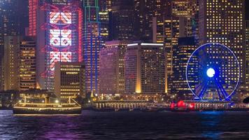 Luxury large touring boat for tourist service in victoria harbor at night view from Kowloon side at Hong Kong. photo