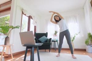 Beautiful asian woman staying fit by exercising at home for healthy trend lifestyle