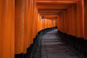 The red torii gates walkway path at fushimi inari taisha shrine the one of attraction  landmarks for tourist in Kyoto, Japan photo