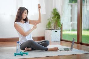 Beautiful asian woman staying fit by exercising at home for healthy trend lifestyle photo