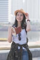 Beautiful asian solo tourist woman  smiling and searching for tourists sightseeing spot. Vacation travel in summer. photo