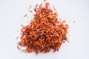 Dried safflower for herbal tea on white background, dry safflower petals, Saffron substitute photo