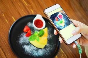 Food photography sweets dessert from smartphone on the dining table - Home made food photo for post in social networks mobile phone photo , selective focus