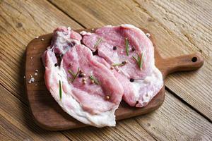 Raw pork meat rosemary with herbs and spices on Wooden board fresh pork photo