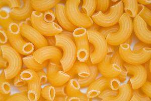 macaroni top view - close up raw macaroni uncooked delicious pasta or penne noodles